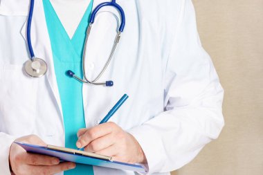 bej arka planda stetoskop ile doktorun kırpılmış görünümü 