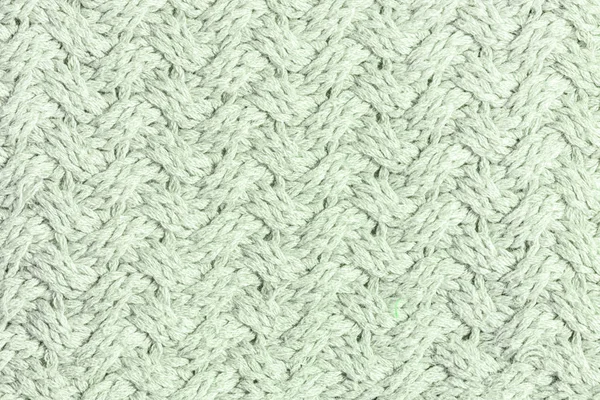 Wool weave. Knitted texture with an unusual pattern close-up. Light gray-green background for layouts. — Stock Photo, Image