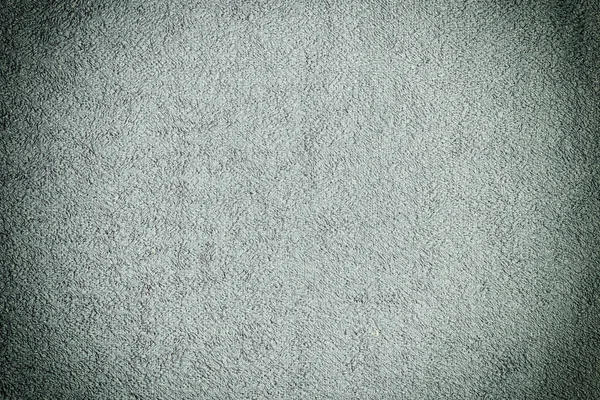 Textura tmavě šedého froté roušky. Rovnoměrně rozložte tkaninu. Pozadí s vinnette. — Stock fotografie