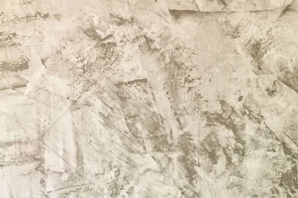 Abstract light gray background. Straya plaster wall with scratches and roughness. The basis for the layout.