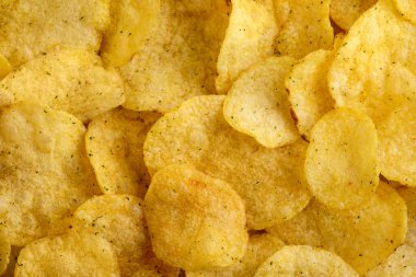 Lezzetli cips gıda arka plan. Oluklu harika altın rengi patatesler pota