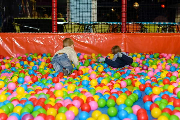 Active happy boys playing in the balls pool — Stock Photo, Image