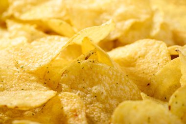 Lezzetli cips gıda arka plan. Oluklu harika altın rengi patatesler pota