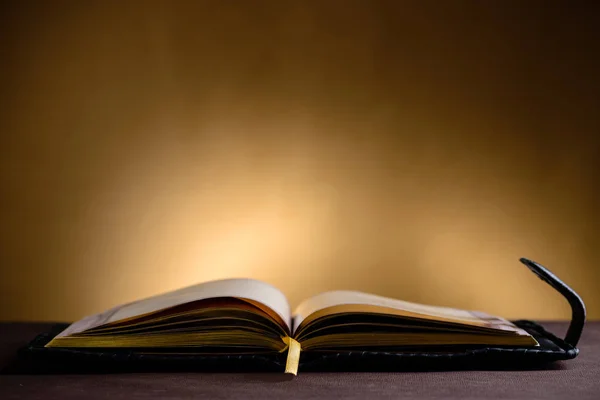 Natureza morta com livro velho aberto na mesa de madeira — Fotografia de Stock