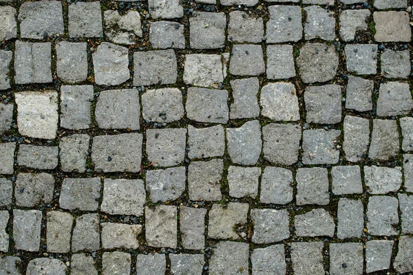 Fundo abstrato de pavimento de paralelepípedo de granito velho. Pavimentação — Fotografia de Stock