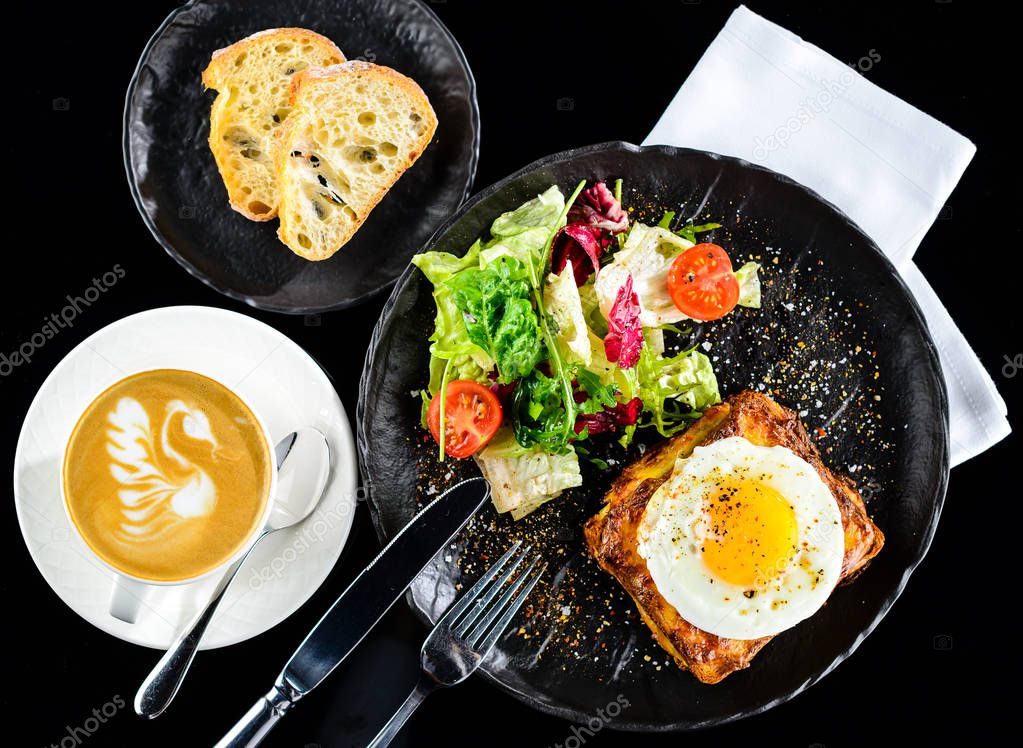 Dish with toast with fried eggs and salad with tomatoes and lett
