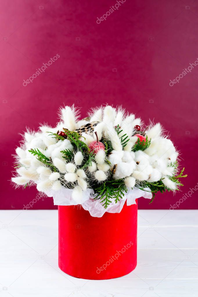 Beautiful creative decorative winter bouquet with berries, cotto