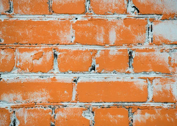 Textura de una pared de ladrillo pintada con pintura naranja — Foto de Stock