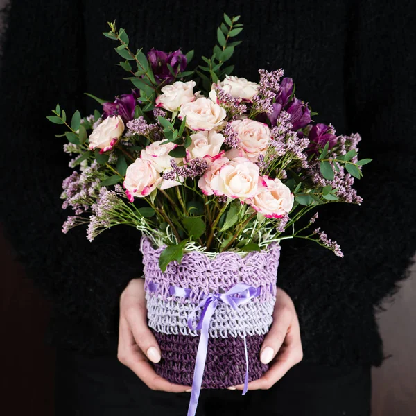 Spring bouquet in pots in hands of a girl — Stock Photo, Image