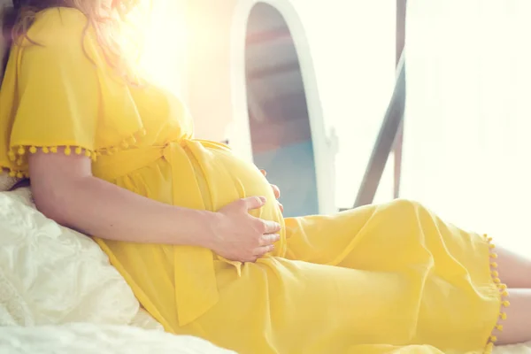 Pregnant woman lies on the bed, Belly closeup — Stock Photo, Image