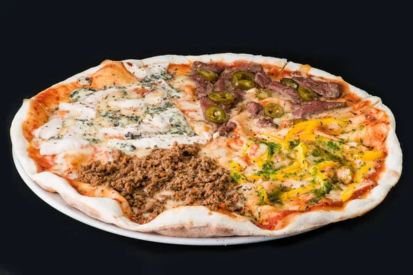 Meat pizza with chicken, beef and sweet pepper on a dark backgro