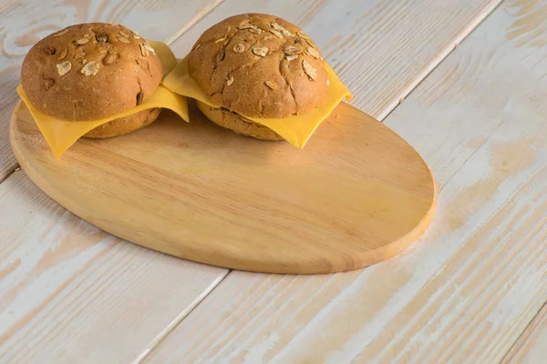 Bollos de pan sobre tabla de madera —  Fotos de Stock