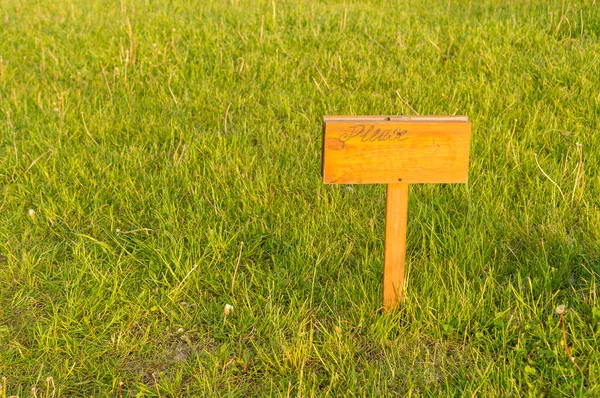 wood sign in the grass