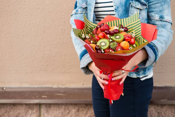 woman holding fruit bouquet