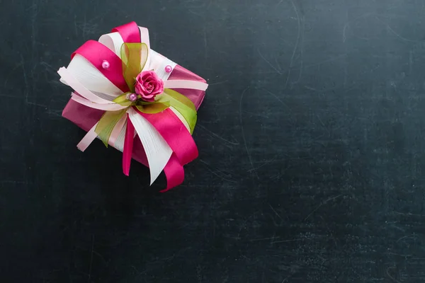 Pequeña caja de regalo rosada hecha a mano con pequeña rosa y cintas en dar — Foto de Stock