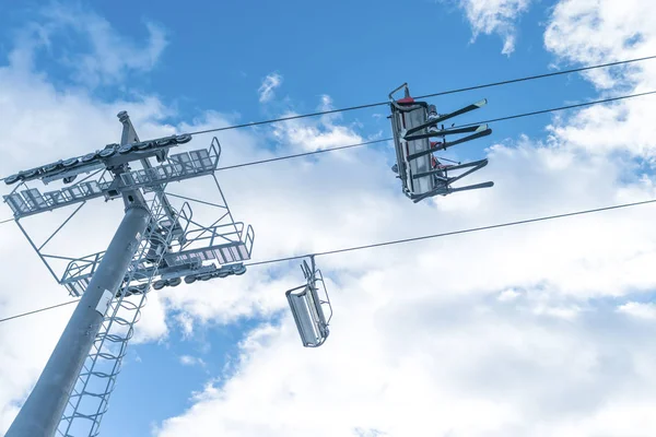 Skiers ride the ski chair lift up — Stock Photo, Image