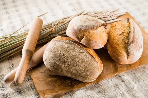 Still life with a traditional round artisan wheat bread loaves, — Stock Photo, Image