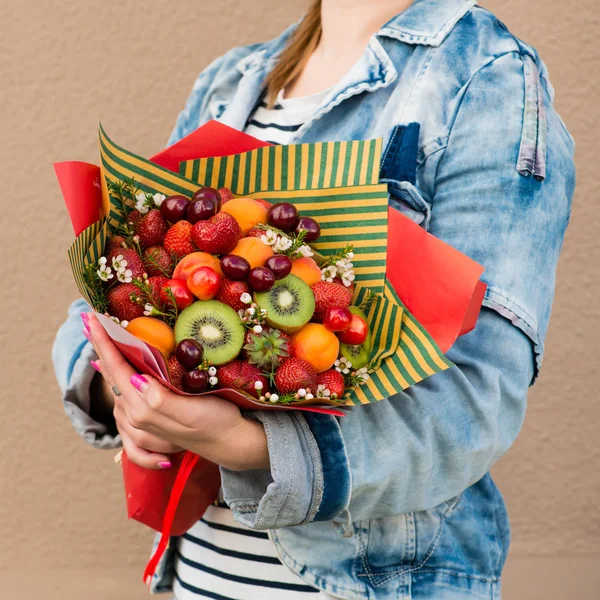 woman holding fruit bouquet