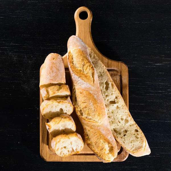 Sliced French fresh bread baguette with poolish and on a wooden — Stock Photo, Image