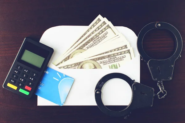 steel police handcuffs, dollars money, payment device and bank c