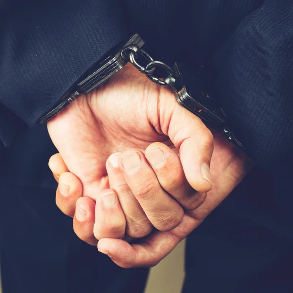 Close-up businessman hands in handcuffs. Businessman bribetaker — Stock Photo, Image