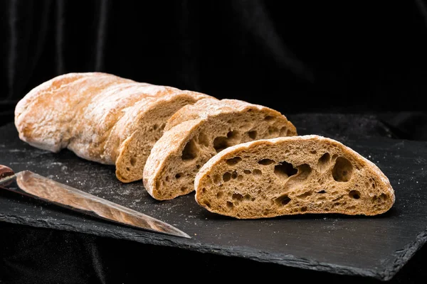 Front view of fresh warm homemade bread on dark background — Stock Photo, Image