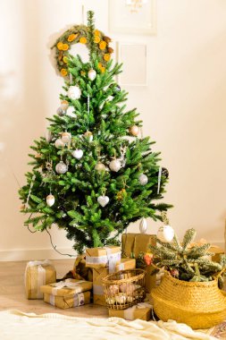 T o altında hediyeleri ile güzel dekore edilmiş Noel ağacı