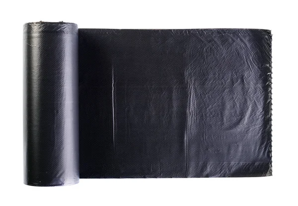 Fekete műanyag polietilén szemetes zsákot, hengerelt, és elszigetelt wh — Stock Fotó