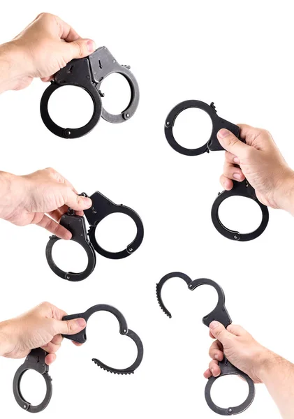 Set of men hands holding handcuffs — Stock Photo, Image