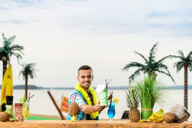 Barın yakınında duran yakışıklı gülümseyen Latin Amerika barmen 