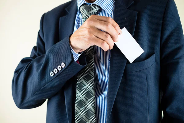 Business man putting business card in a pocket with copyspace, m