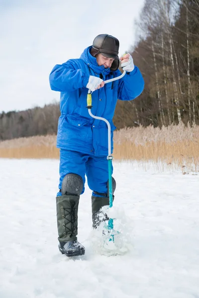 Firsheman captura de peixe no lago no inverno dia frio — Fotografia de Stock