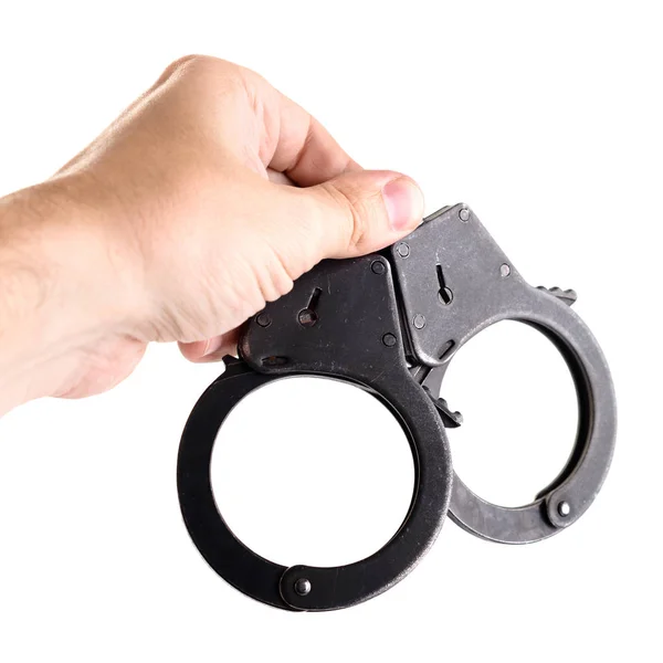 Close-up of man hand holding closed handcuffs, isolated on white — Stock Photo, Image