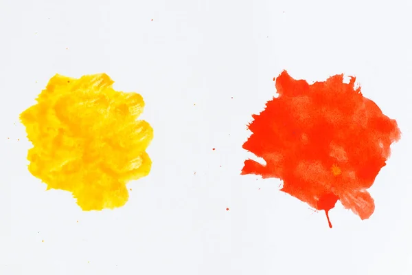 Red and yellow paint splatters. Paint splashes on white backgrou