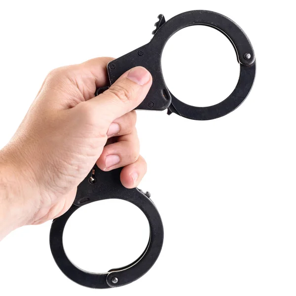 Close-up of man hand holding closed handcuffs, isolated on white — Stock Photo, Image