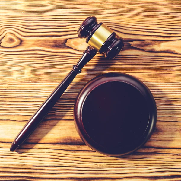 Judges gavel and sound block on wooden background, toned image. — Stock Photo, Image