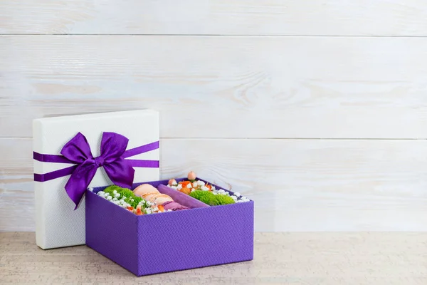 gift box with flowers and macaroon