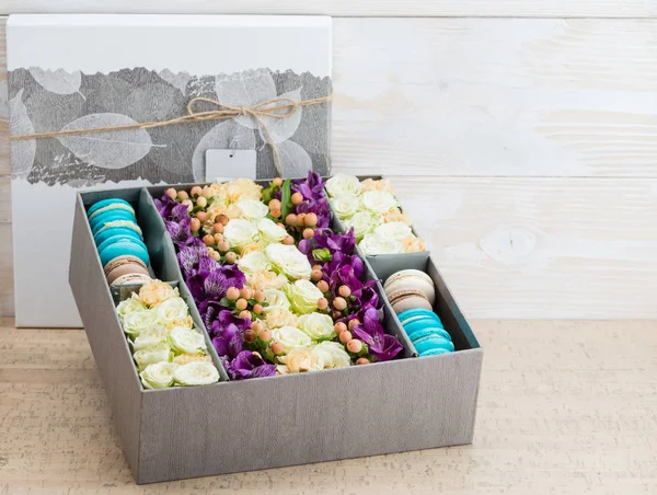 Box with flowers and macaroons