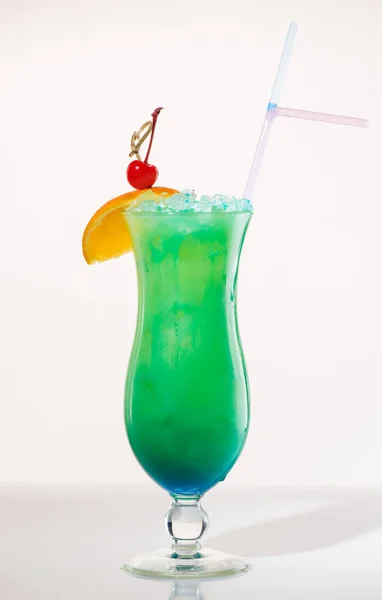Exotic cocktail green decorated with orange and cherry — Stock Photo, Image