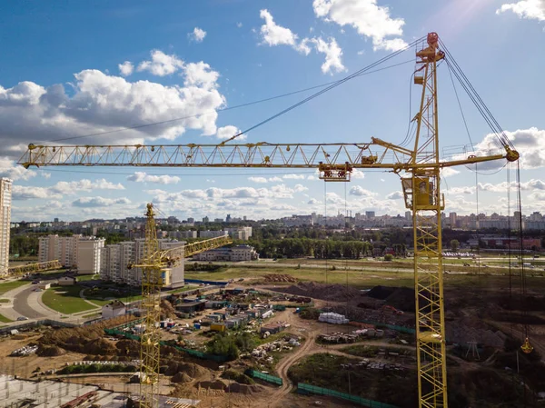 Aerial drone view Cranes close-up on construction site against blue sky — Stock Photo, Image