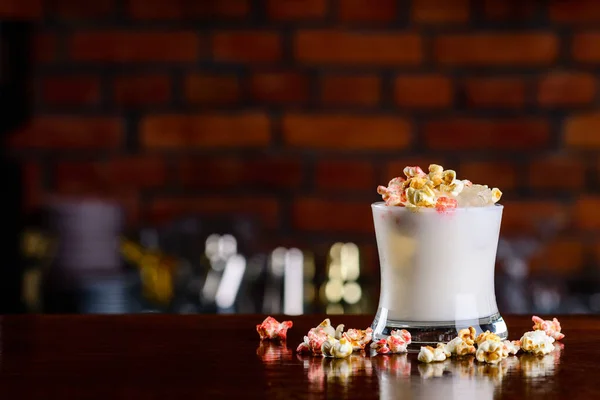 Buttered Popcorn Cocktail closeup on bar counter with copy space