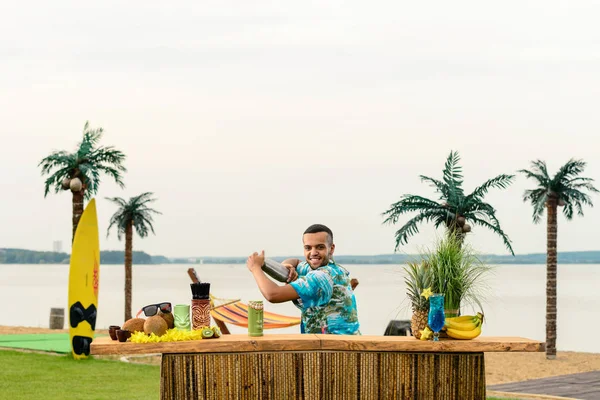 bartender's work on the beach resort, mexican bartender making a cocktail on the beach for relaxing