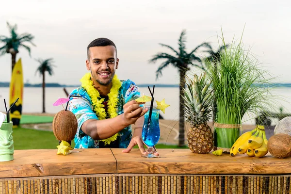 bartender\'s work on the beach resort, mexican bartender making a cocktail on the beach for relaxing