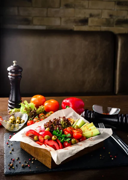 fresh vegetables in a restaurant served, cucumber, peppers, tomatoes and salad