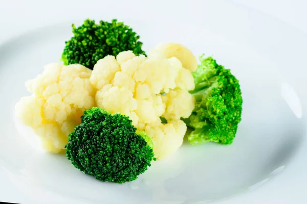 white and green broccoli closeup on light background