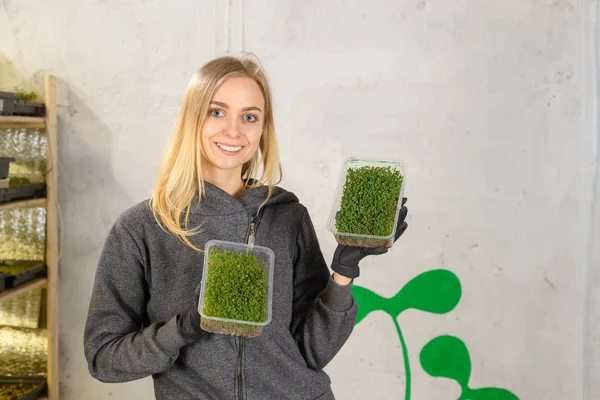 Portrait of blonde girl in a home mini farm plants micro greens home business