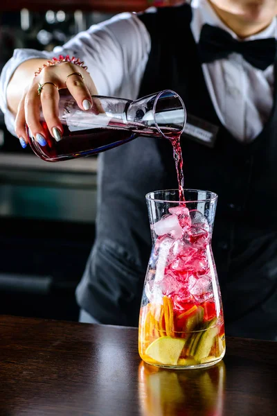 Bartender making Red Sangria in Italian restaurant. Sangria cocktail with red wine
