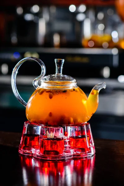 Sea buckthorn tea in glass teapot — Stock Photo, Image