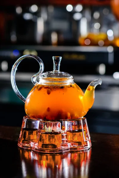 Sea buckthorn tea in glass teapot — Stock Photo, Image