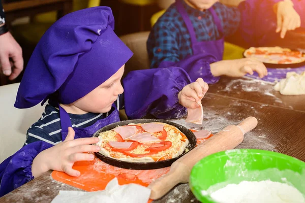 Little cook. Children make pizza. Master class for children on cooking Italian pizza